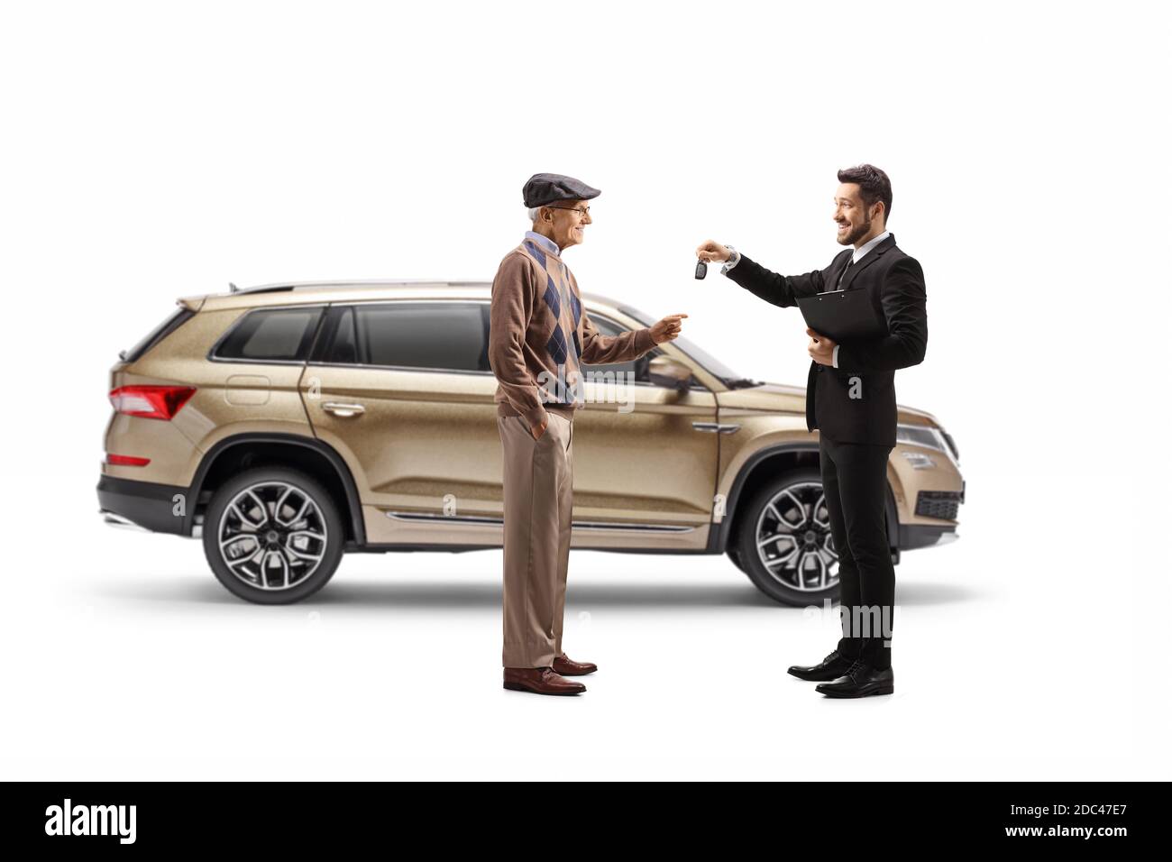 Full length profile shot of a salesman giving car keys from a SUV to an elderly customer isolated on white background Stock Photo