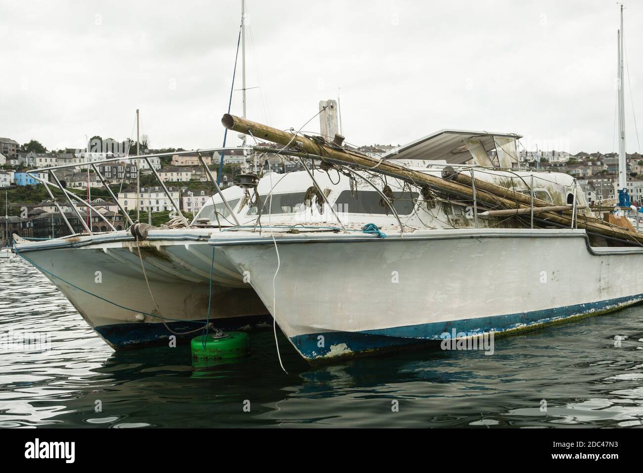 Dismasted Catalac Catamaran at anchor Stock Photo