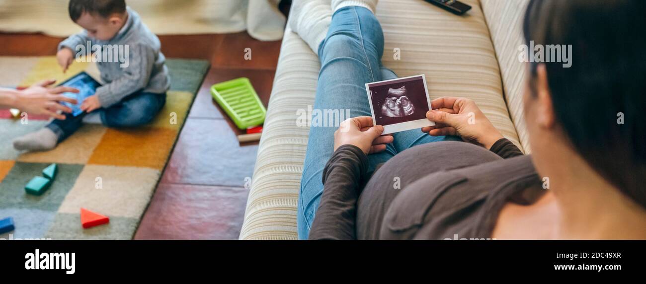 Pregnant looking ultrasound of their new baby Stock Photo