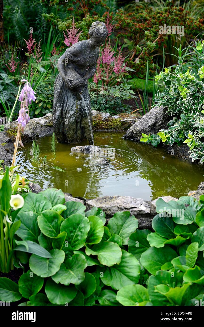 lady liberty water feature,water fountain,garden feature,garden pond,pouring water,water pour,garden feature,water display,gardens,female,woman,figure Stock Photo