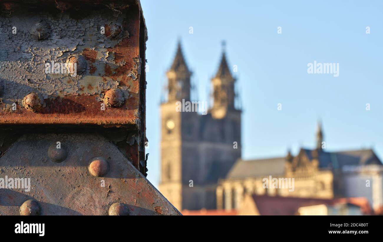 Detail of the ailing lift bridge on the Elbe in Magdeburg. In the background the Magdeburg Cathedral. Stock Photo