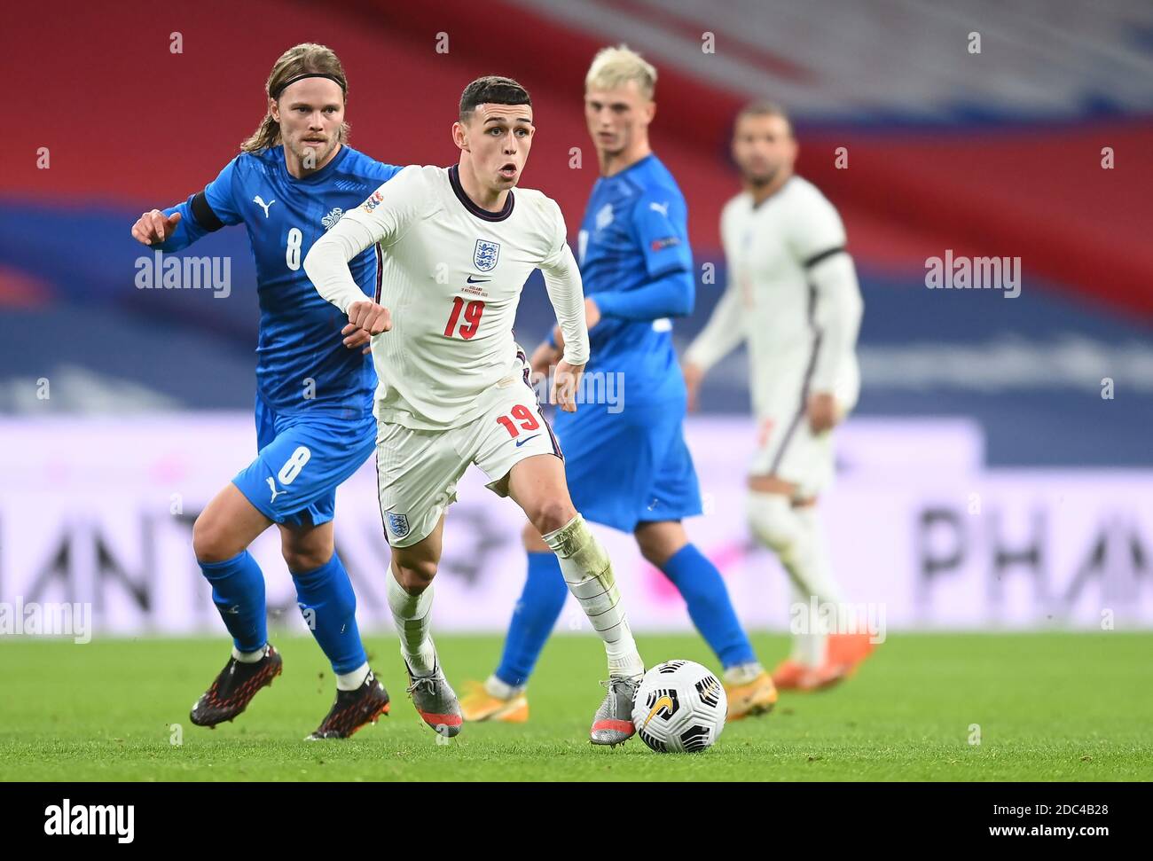 Iceland's Birkir Bjarnason (left) and England's Phil Foden in action during the UEFA Nations League match at Wembley Stadium, London. Stock Photo
