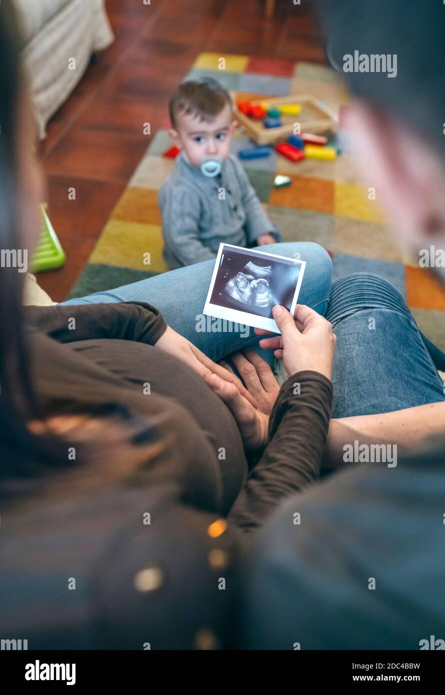 Parents looking ultrasound of their new baby Stock Photo