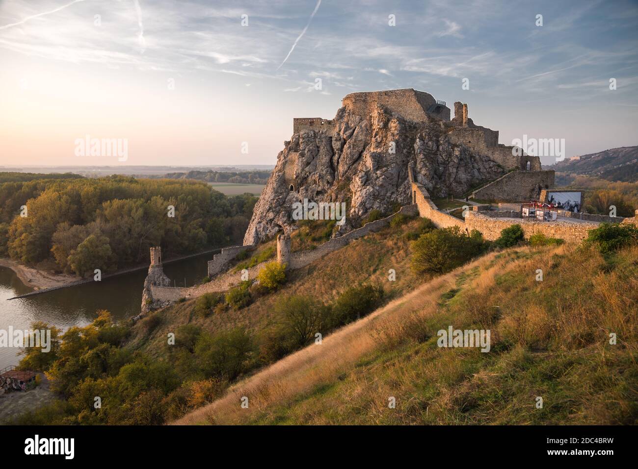 Famous Devin Castle Ruin Located at Confluence of Danube River and Morava River near Bratislava, Slovakia at Sunset Stock Photo