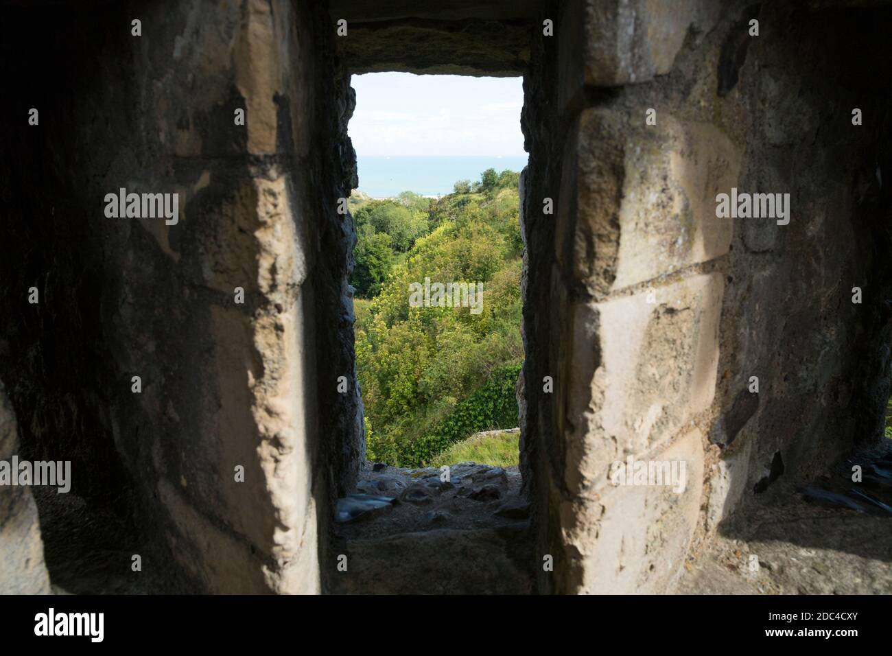 Arrow slit / arrow loop / arrow hole / holes / slits (3 together, to cover a wide angle) in the defensive wall Dover Castle, Dover, Kent. UK. (121) Stock Photo