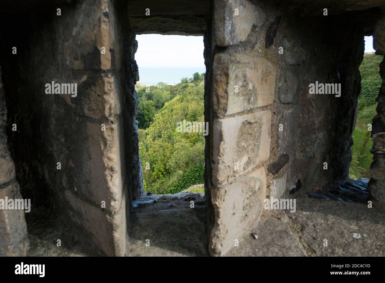 Arrow slit / arrow loop / arrow hole / holes / slits (3 together, to cover a wide angle) in the defensive wall Dover Castle, Dover, Kent. UK. (121) Stock Photo
