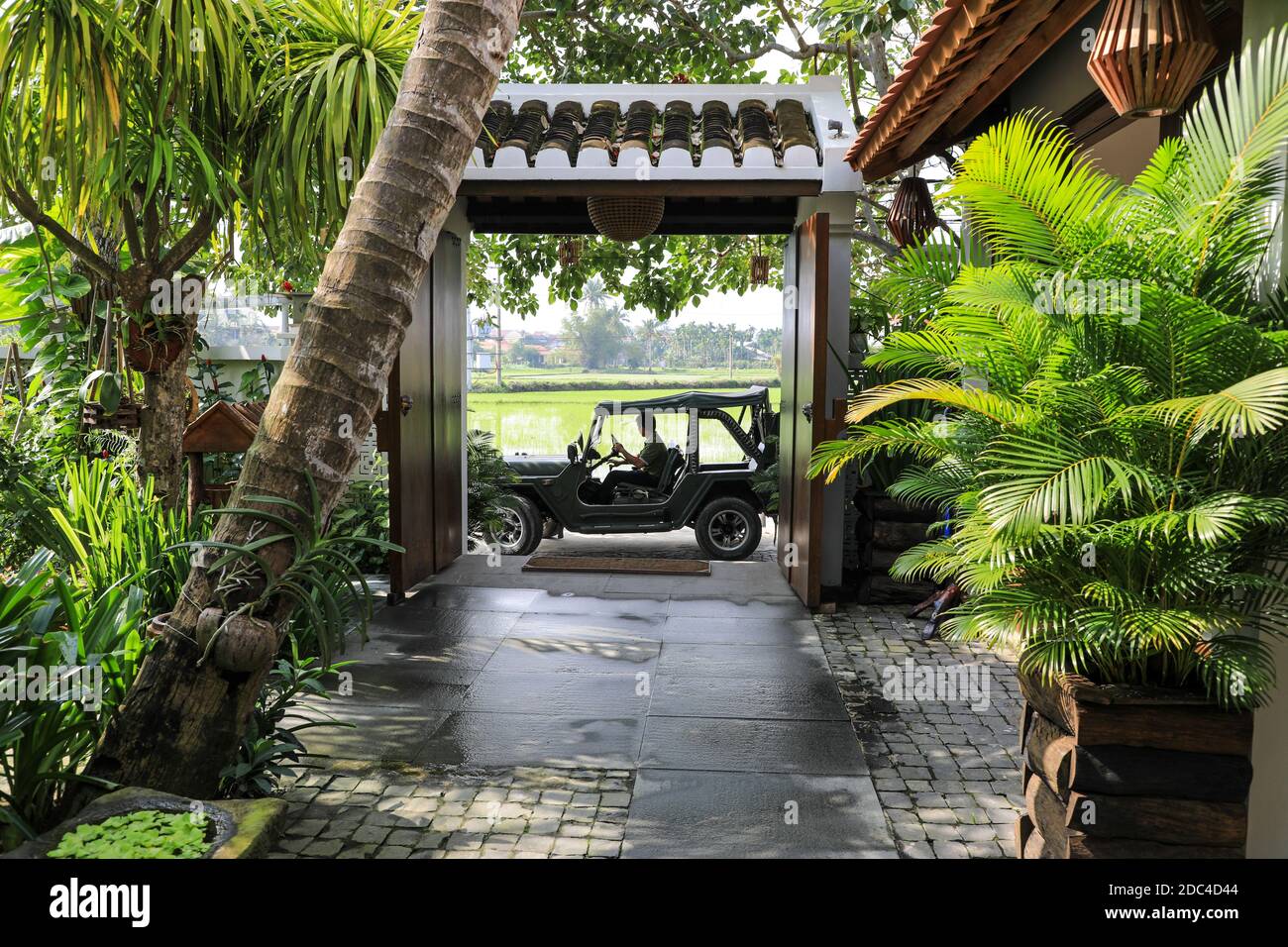 A Jeep used to transport guests waiting at the entrance to the Hoi An Chic green retreat hotel, Hoi An, Vietnam, Asia Stock Photo