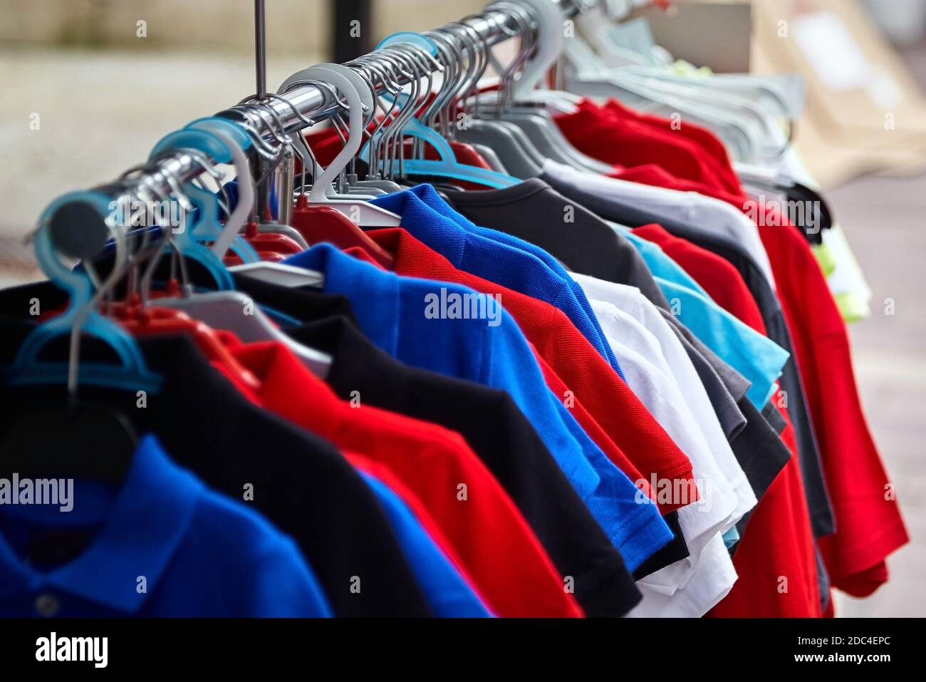 Colorful polo t-shirt for the man on hangers in a retail shop Stock Photo