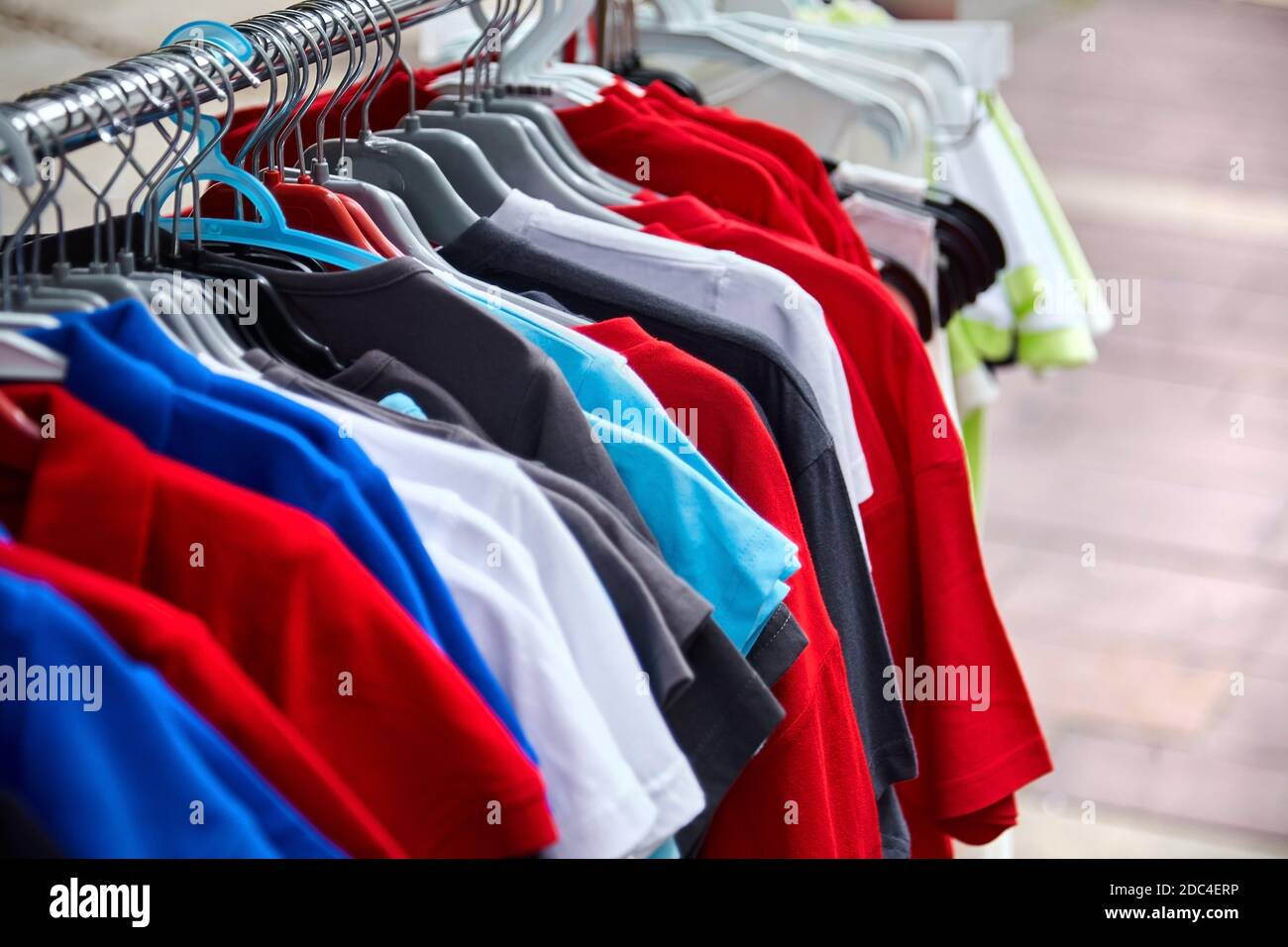 Colorful polo t-shirt for the man on hangers in a retail shop Stock ...