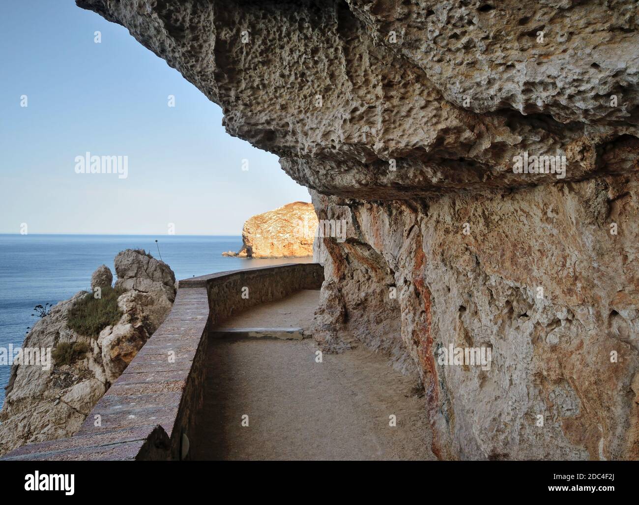 glimpse of the stairway called Escala del Cabirol carved on the rock of the Capo Caccia promontory that leads to the Grotte di Nettuno in the Mediterr Stock Photo