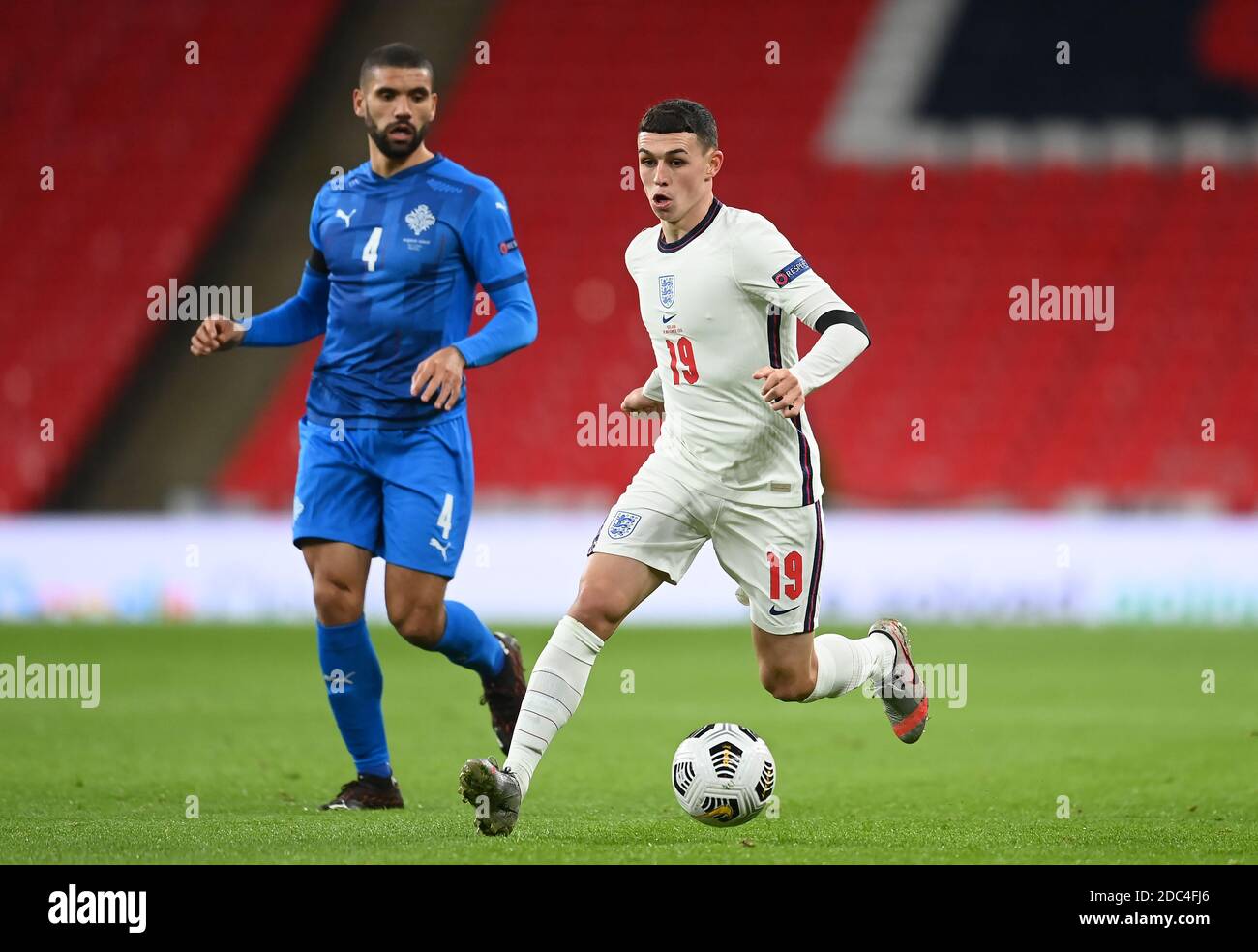 Iceland's Victor Palsson (left) and England's Phil Foden in action during the UEFA Nations League match at Wembley Stadium, London. Stock Photo