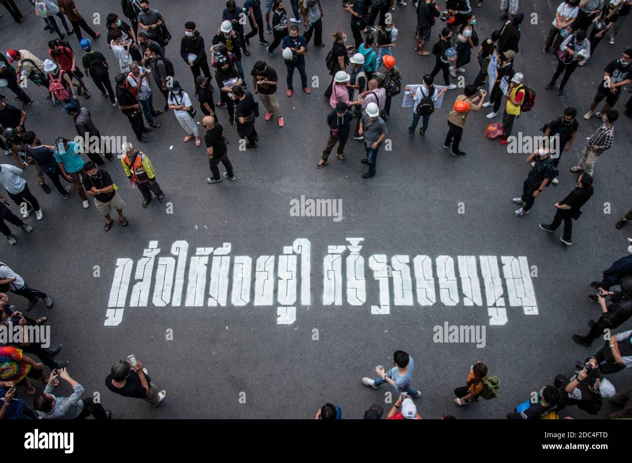 A message from pro-democracy protesters that says 'I command you to be under the constitution' seen on the street floor during the demonstration.Pro-democracy protesters gathered at Ratchaprasong intersection and marched towards the royal Thai police headquarter to splash colour and water following riot police using tear gas and high-pressure water cannons to prevent protesters from approaching Congress during the constitutional debate. Stock Photo