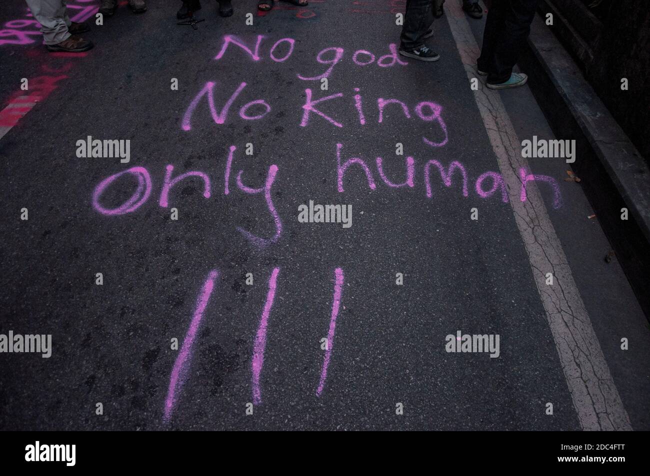 An anti monarchy message seen on the street floor during the demonstration.Pro-democracy protesters gathered at Ratchaprasong intersection and marched towards the royal Thai police headquarter to splash colour and water following riot police using tear gas and high-pressure water cannons to prevent protesters from approaching Congress during the constitutional debate. Stock Photo