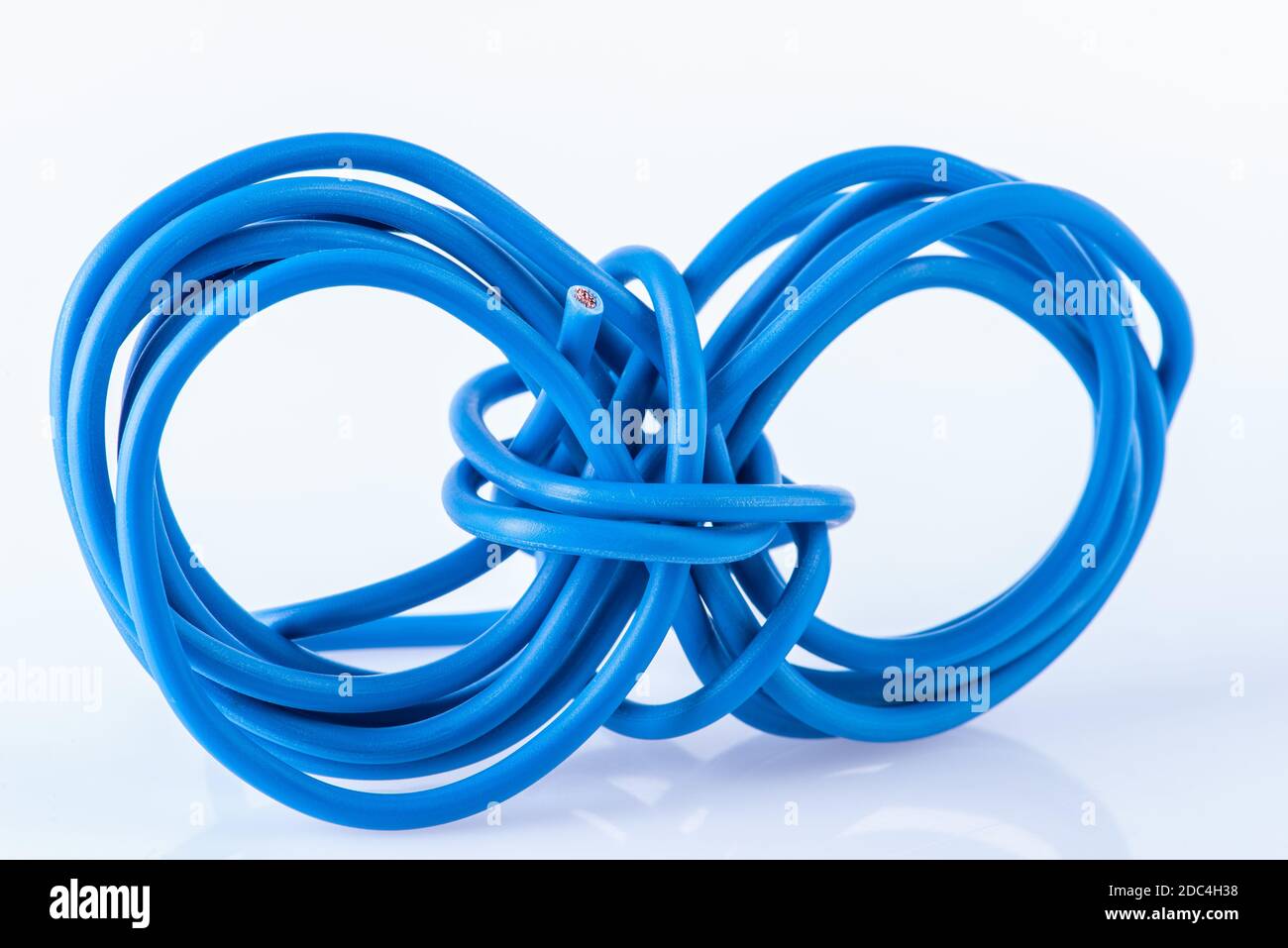 Scroll of scrap electric copper cable used in electrical installation, close-up Stock Photo