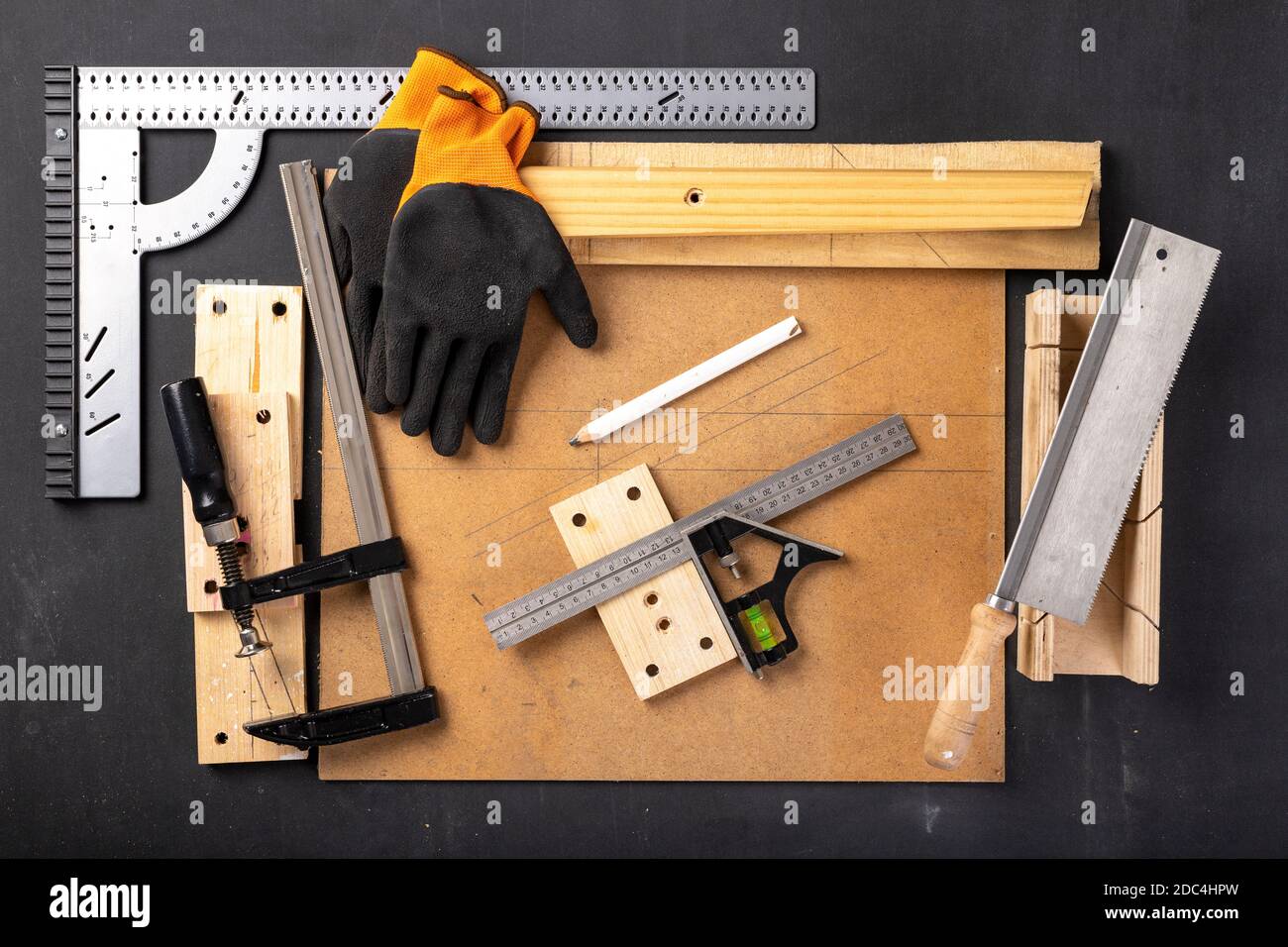 A table in a home carpentry workshop. Woodworking accessories at the  carpenter's stand. Dark background Stock Photo - Alamy
