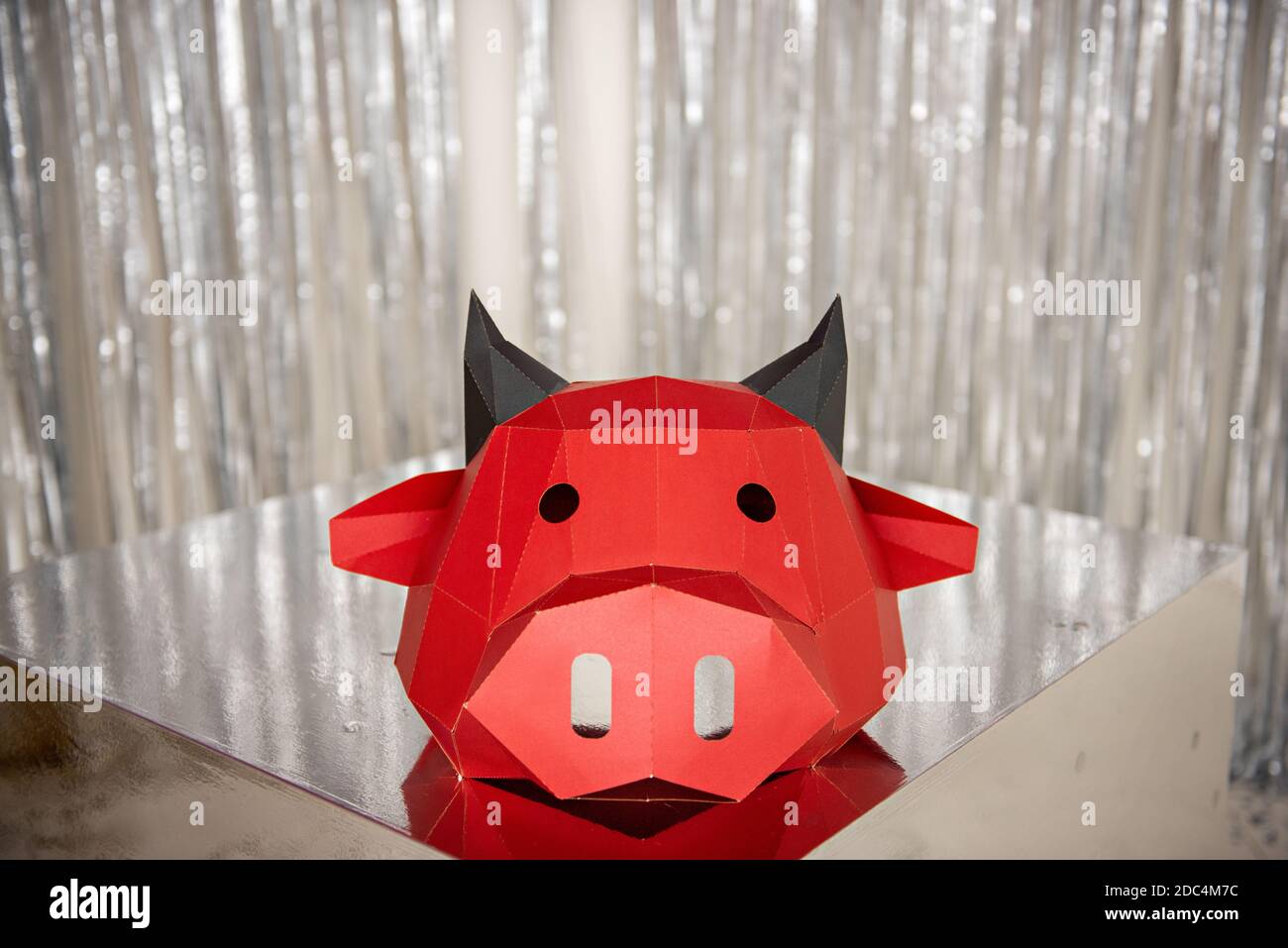 Bright, shiny new year bull festive card. Christmas Red ox head against a background of silver, gold bokeh. Calendar blank, internet banner. 3D mask m Stock Photo