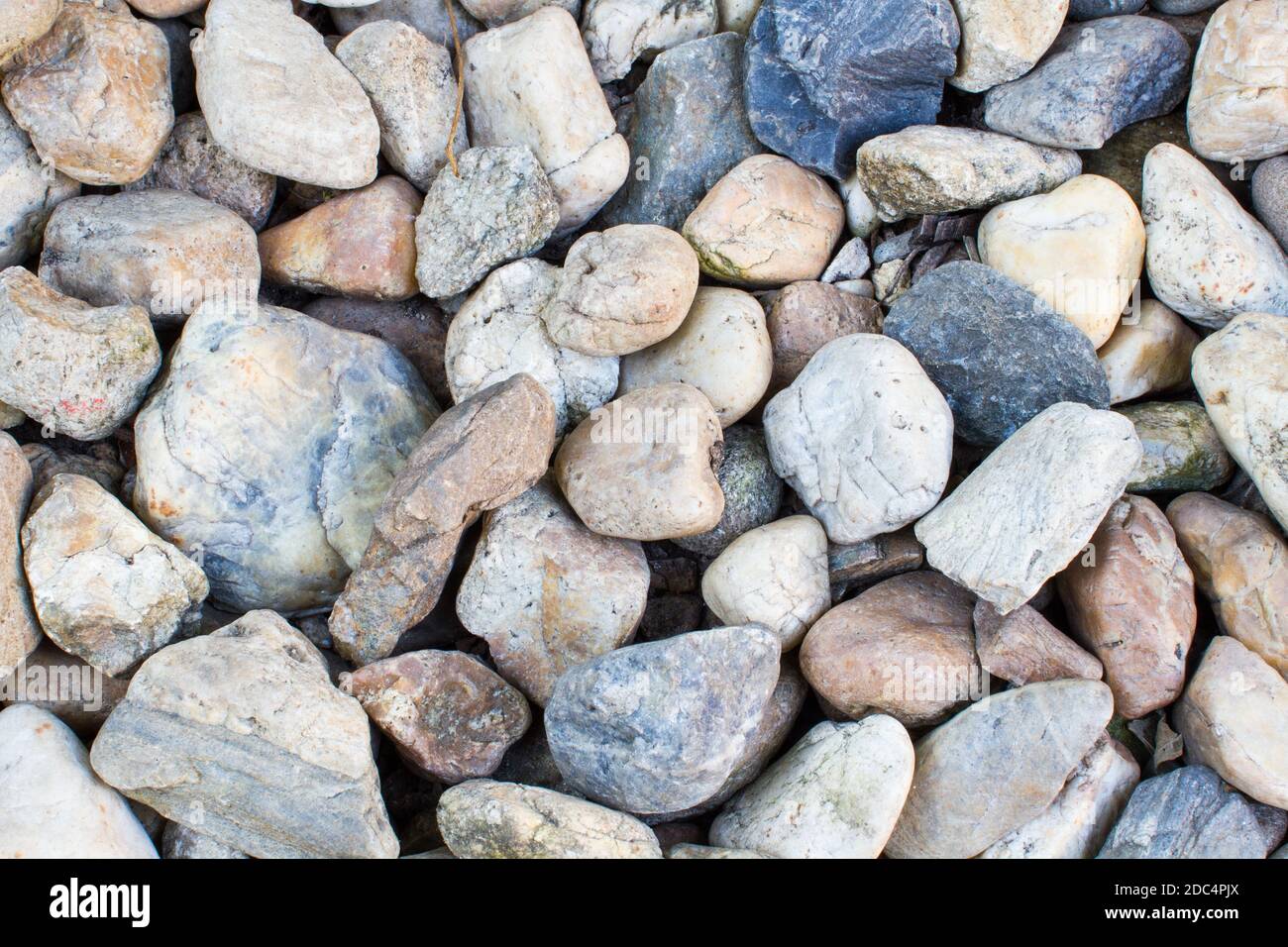 Pebbles as a background image on the ground Stock Photo - Alamy