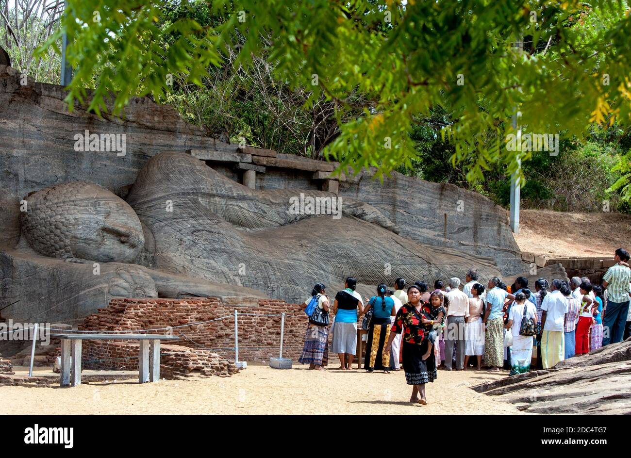 The Gal Vihara includes a reclining, a standing and two seated Buddha statues carved out of a single slab of granite rock at Polonnaruwa, Sri Lanka. Stock Photo