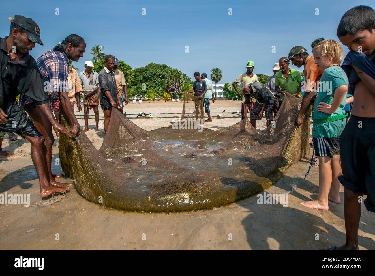 After hours of hauling in their Seine fishing net onto Uppuveli beach in  eastern Sri Lanka the fishermen have little to show for all their hard work  Stock Photo - Alamy