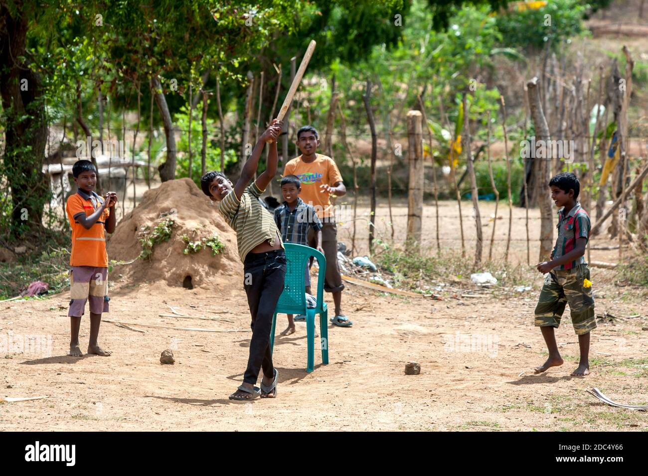 Sri Lankan boys play a game of cricket on a dusty pitch near the town of Pottuvil on the east coast of Sri Lanka. Stock Photo