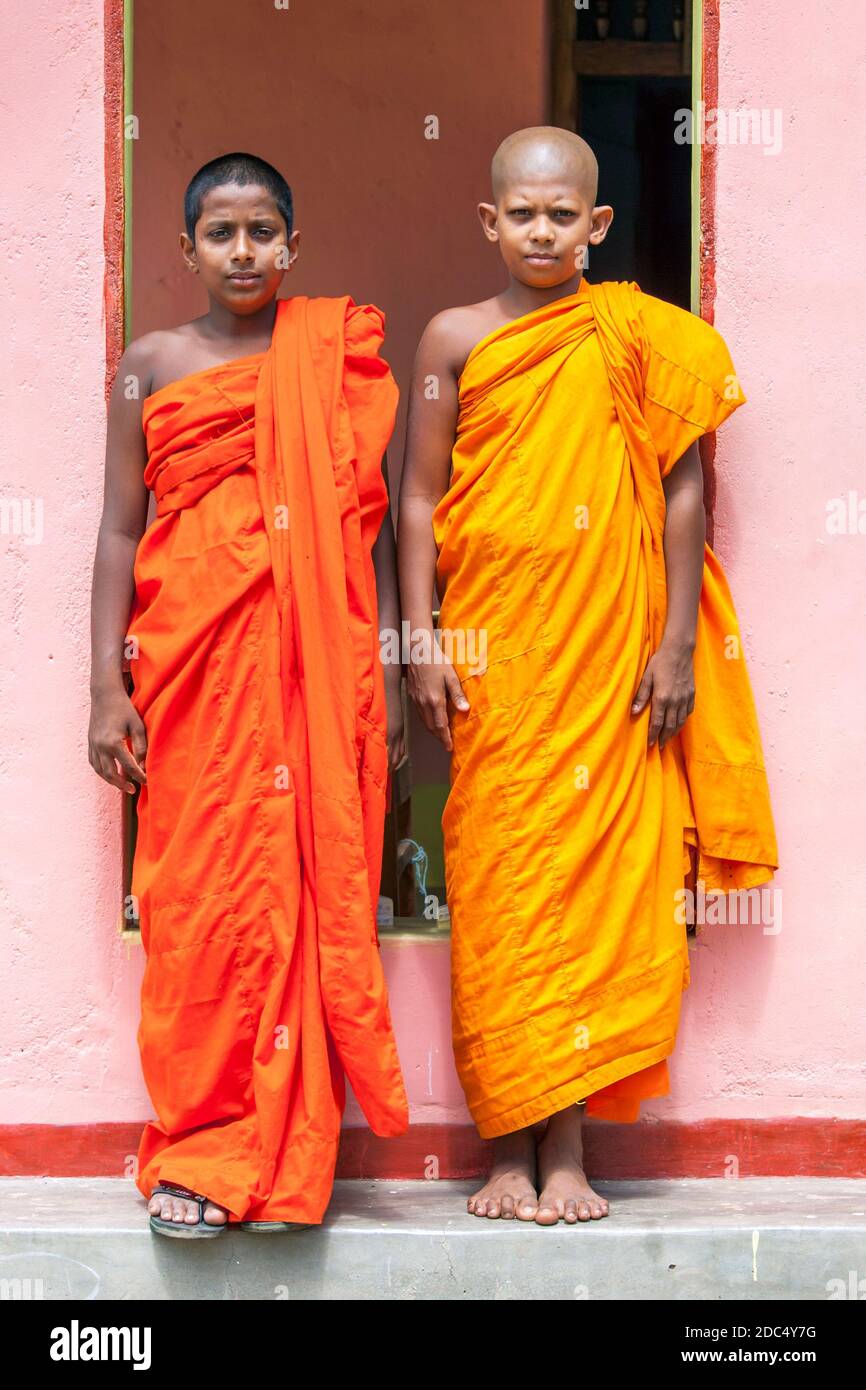 Novice Buddhist monks standing in front of the residence at Lahugala Magul Mahavihara, near Pottuvil on the east coast of Sri Lanka. Stock Photo