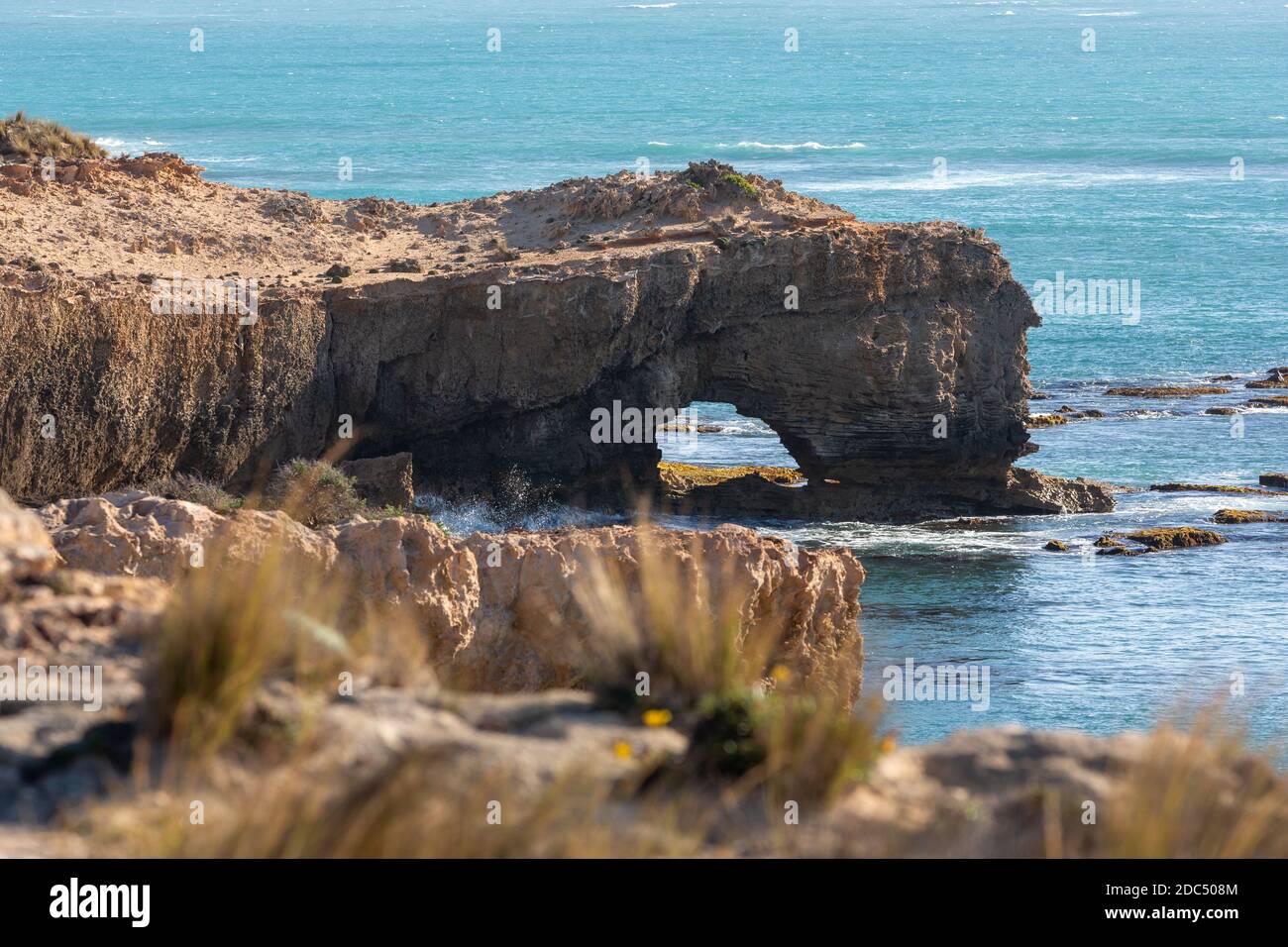A whole formed in the cliff face through erosion at Robe South ...