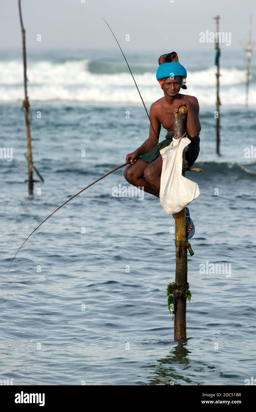 A pole fisherman (stick fisherman) at work in the Indian Ocean in the early  morning at Koggala on the south coast of Sri Lanka Stock Photo - Alamy