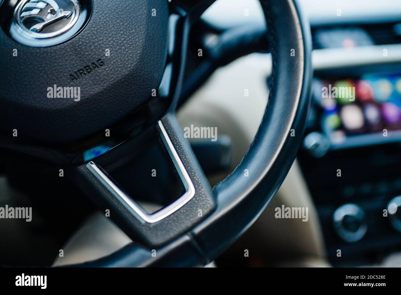 Paris, France - Nov 11, 2020: Detail of a steering wheel with Airbag sign and CarPlay screen dashboard in background Stock Photo