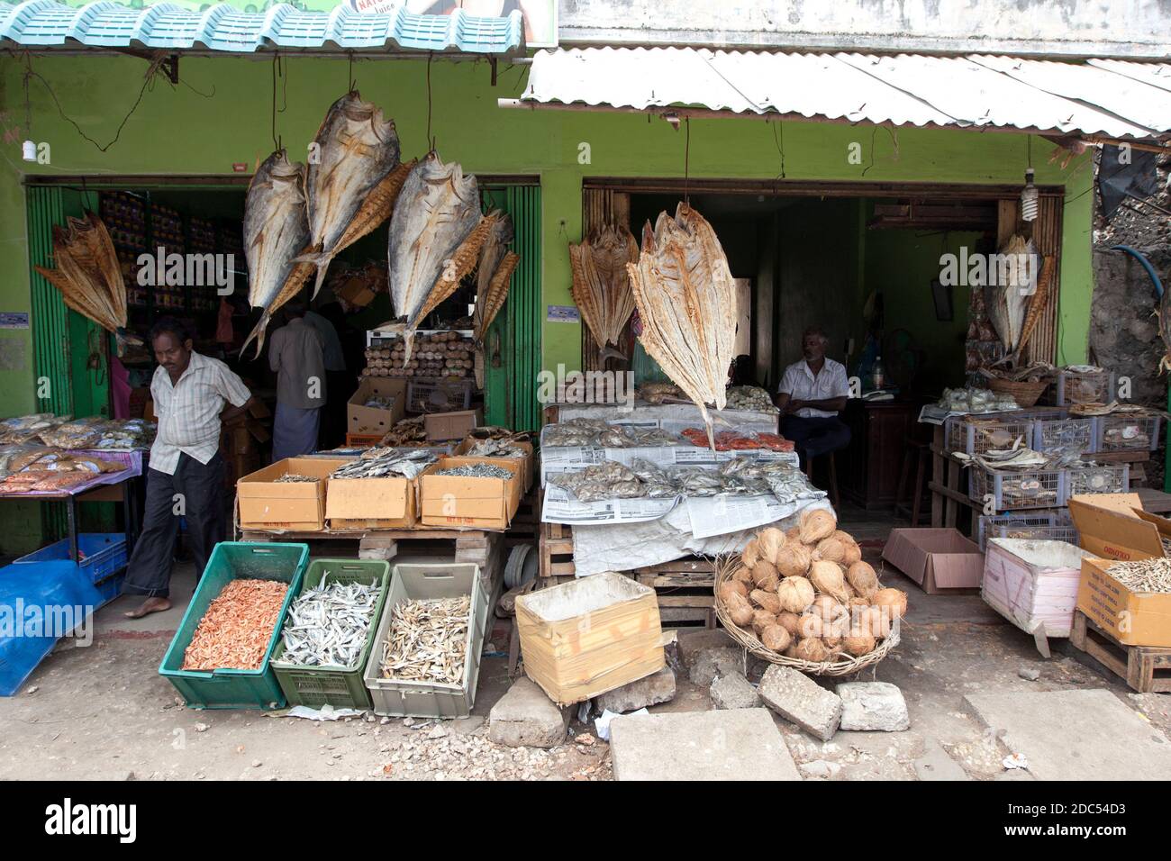 Dried fish hanging from the roof of shops and displayed in containers at Jaffna in the northern region of Sri Lanka. Stock Photo
