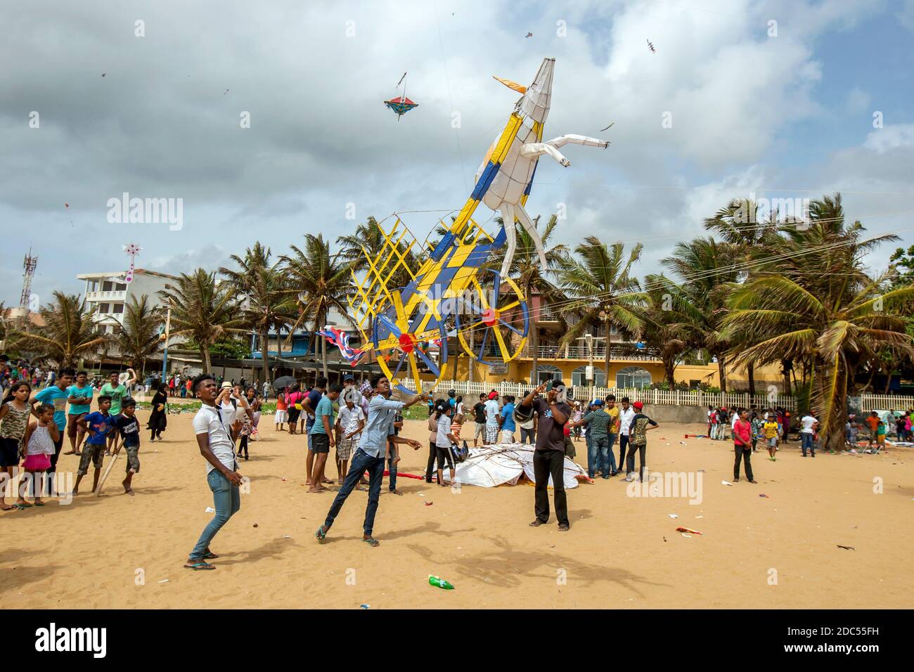 An unique kite shaped like a horse and cart takes to the sky above