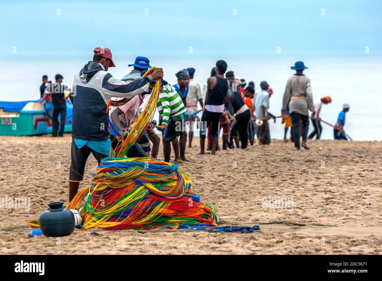 Beach seine fishermen pull the colourful rope attached to their