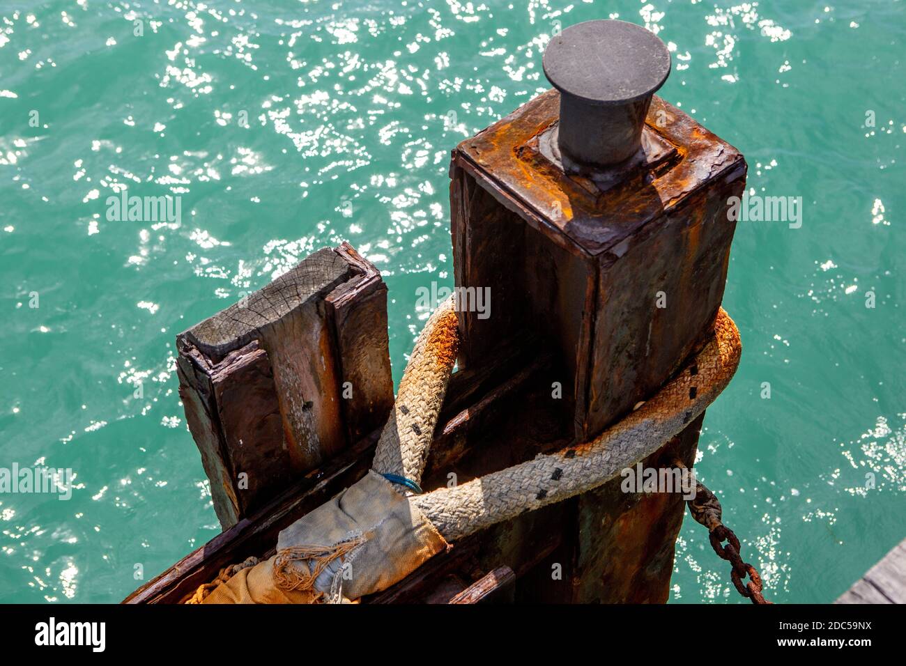 A rusted mooring point and rope on the beachport jetty in beachport