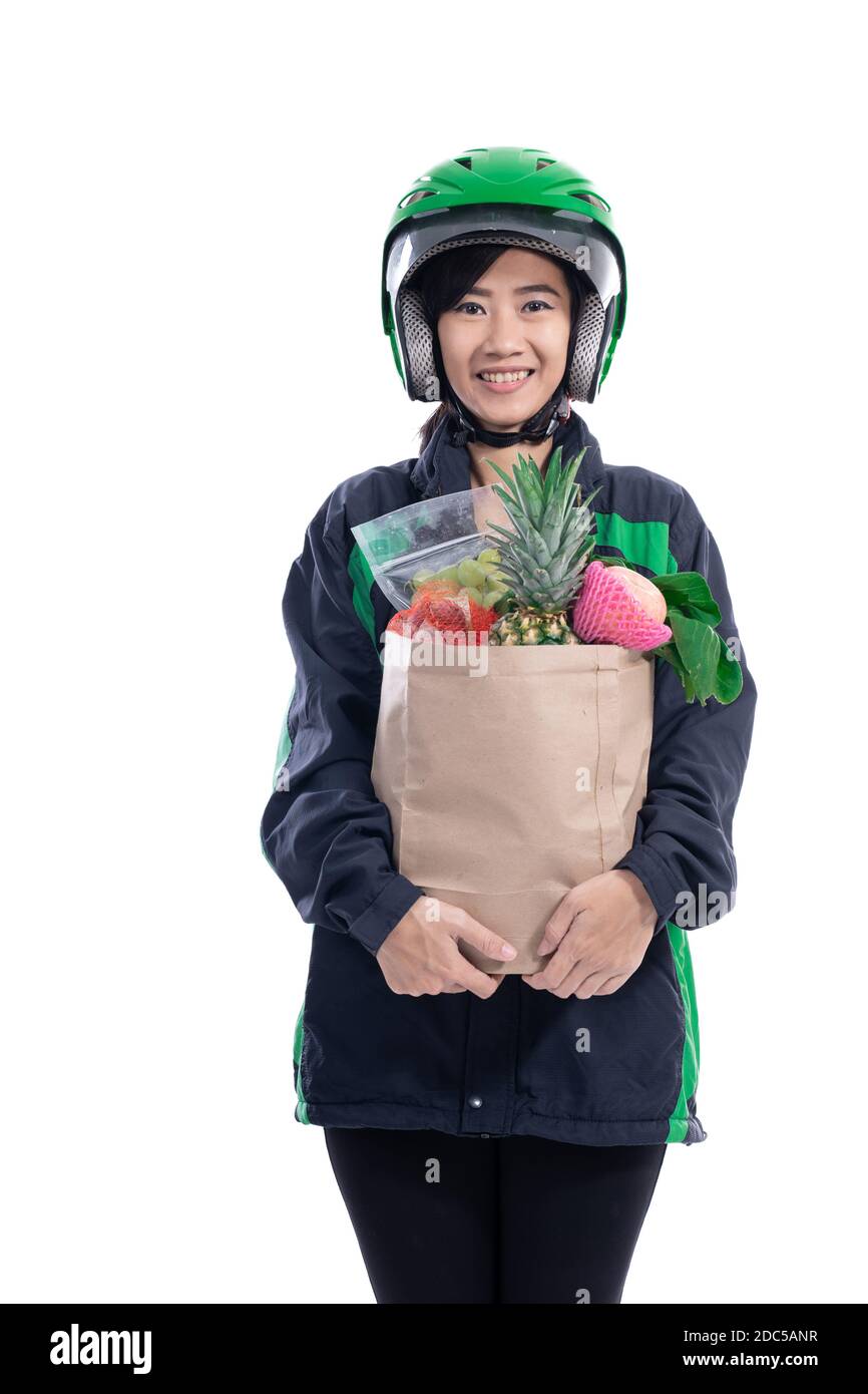 female uber delivery courier wearing helmet bring groceries in the bag Stock Photo Alamy