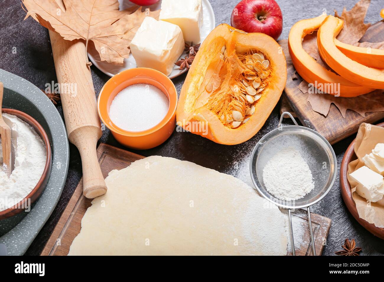 Ingredients for preparing pumpkin pie on dark background Stock Photo