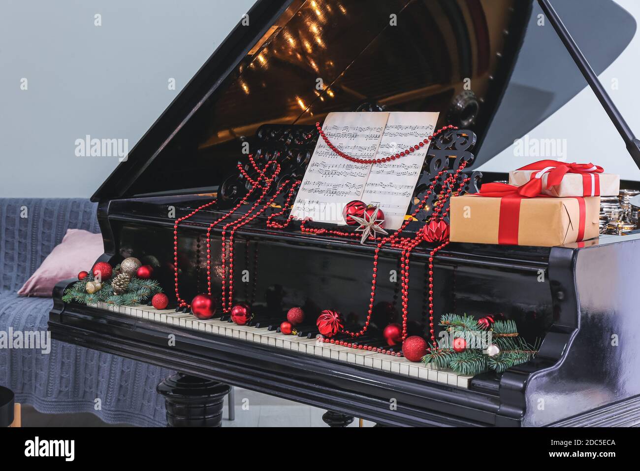 Grand piano decorated for Christmas in room Stock Photo - Alamy