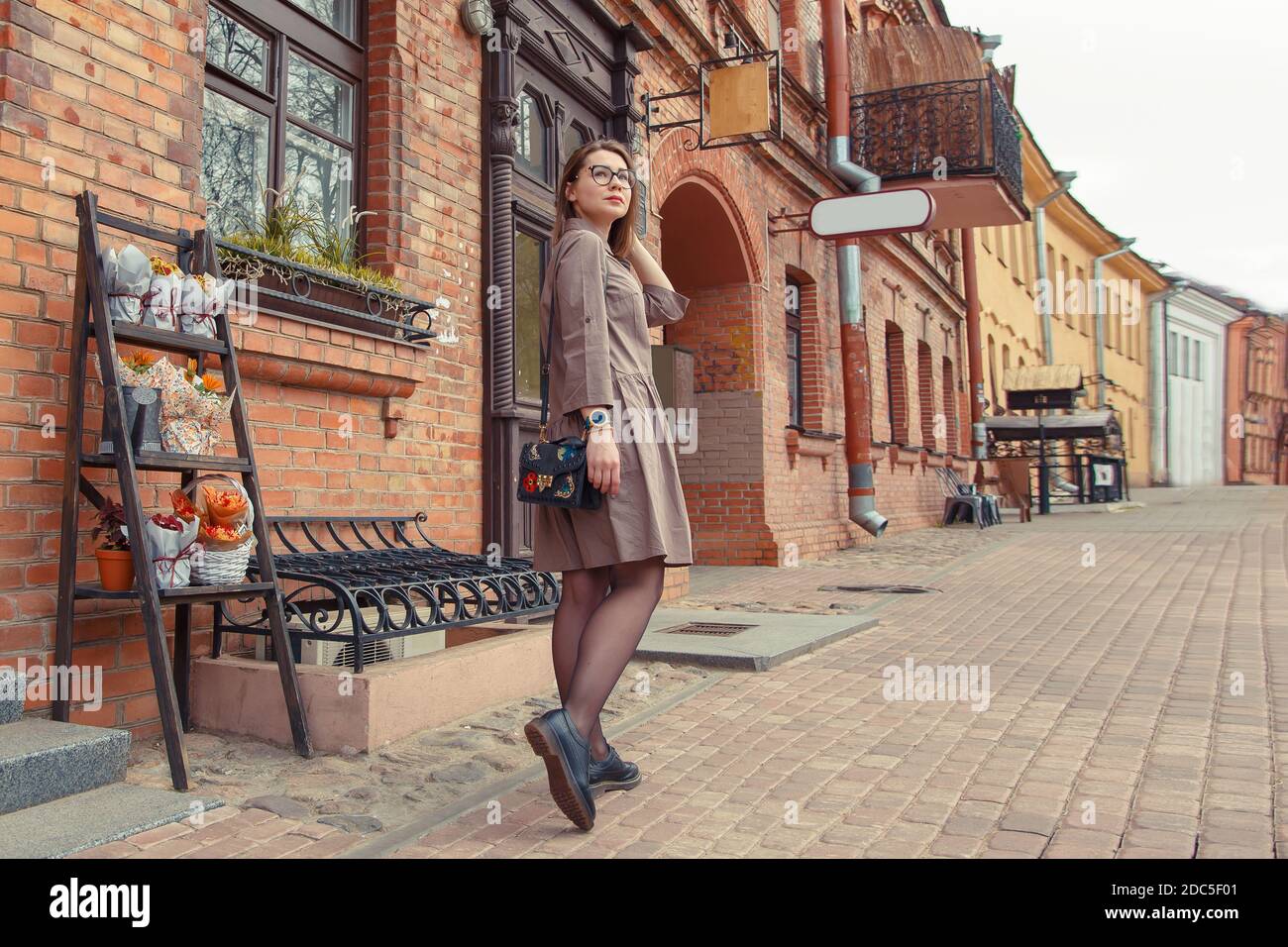 Beautiful woman traveler on the old town street. Stock Photo