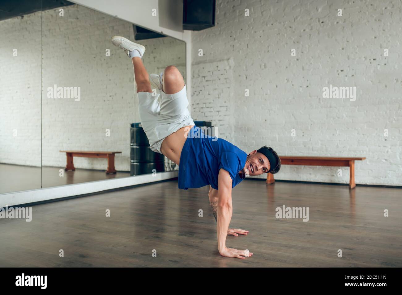 Man doing a handstand on the floor while dancing Stock Photo