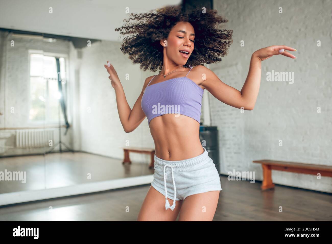Woman doing active and bright dance routine Stock Photo