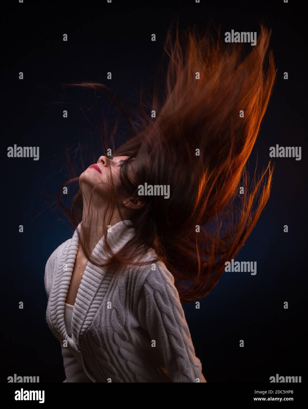 Photo of brunette young woman shaking long hair Stock Photo - Alamy