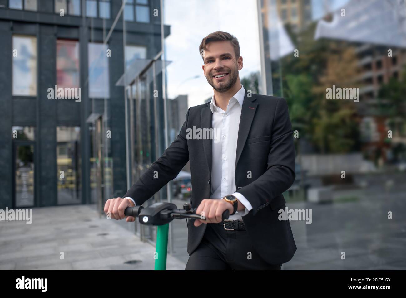 Man in suit on electric scooter hi-res stock photography and images - Alamy