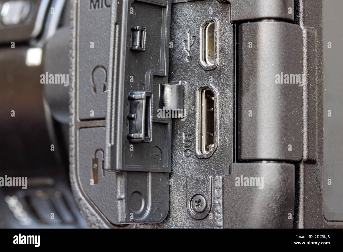 An open door on the side of the camera where is the slots for connection micro USB and mini HDMI. Stock Photo