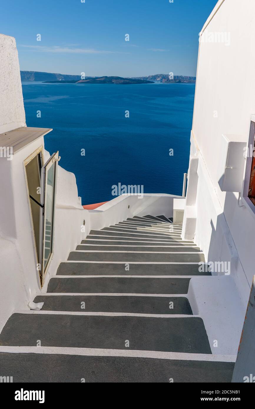 Traditional narrow stairs leading to the sea in Oia Santorini Island, Greece. Stock Photo