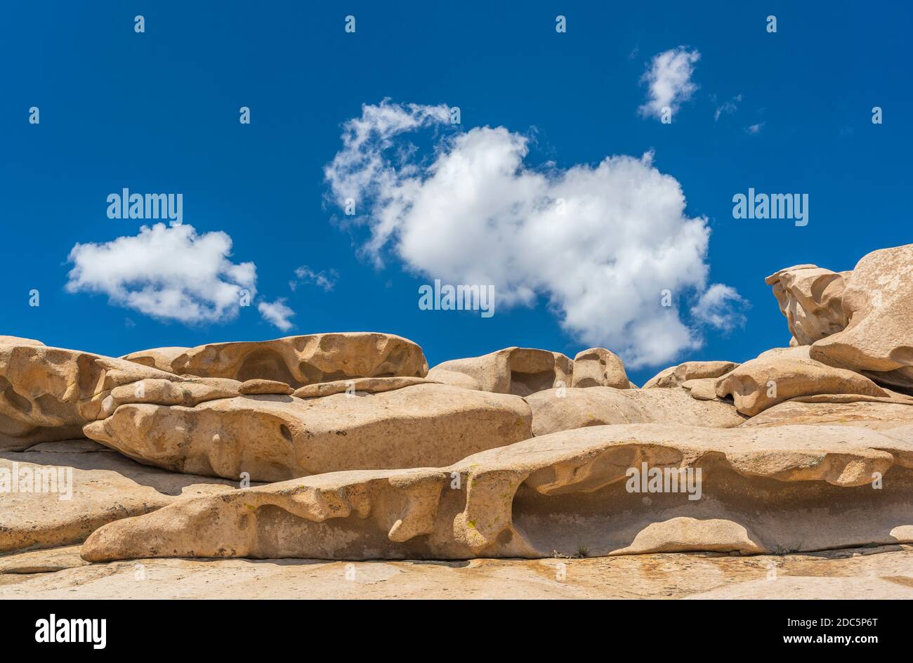 Rock formations in Bektau Ata in Kazakhstan with sculptures on a summers day. Stock Photo