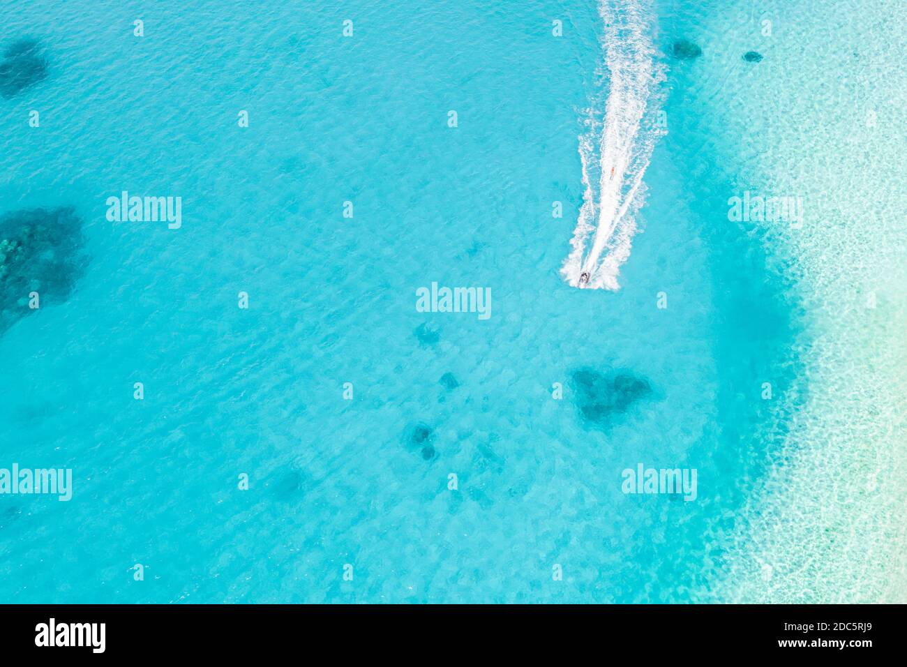 Aerial view of floating water scooter in blue water at sunny day in
