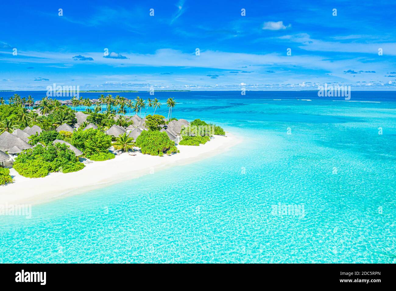 Aerial view of beach in Maldives luxury resort villas, bungalows. Seascape, paradise island landscape, tropical nature pattern. Amazing drone view Stock Photo