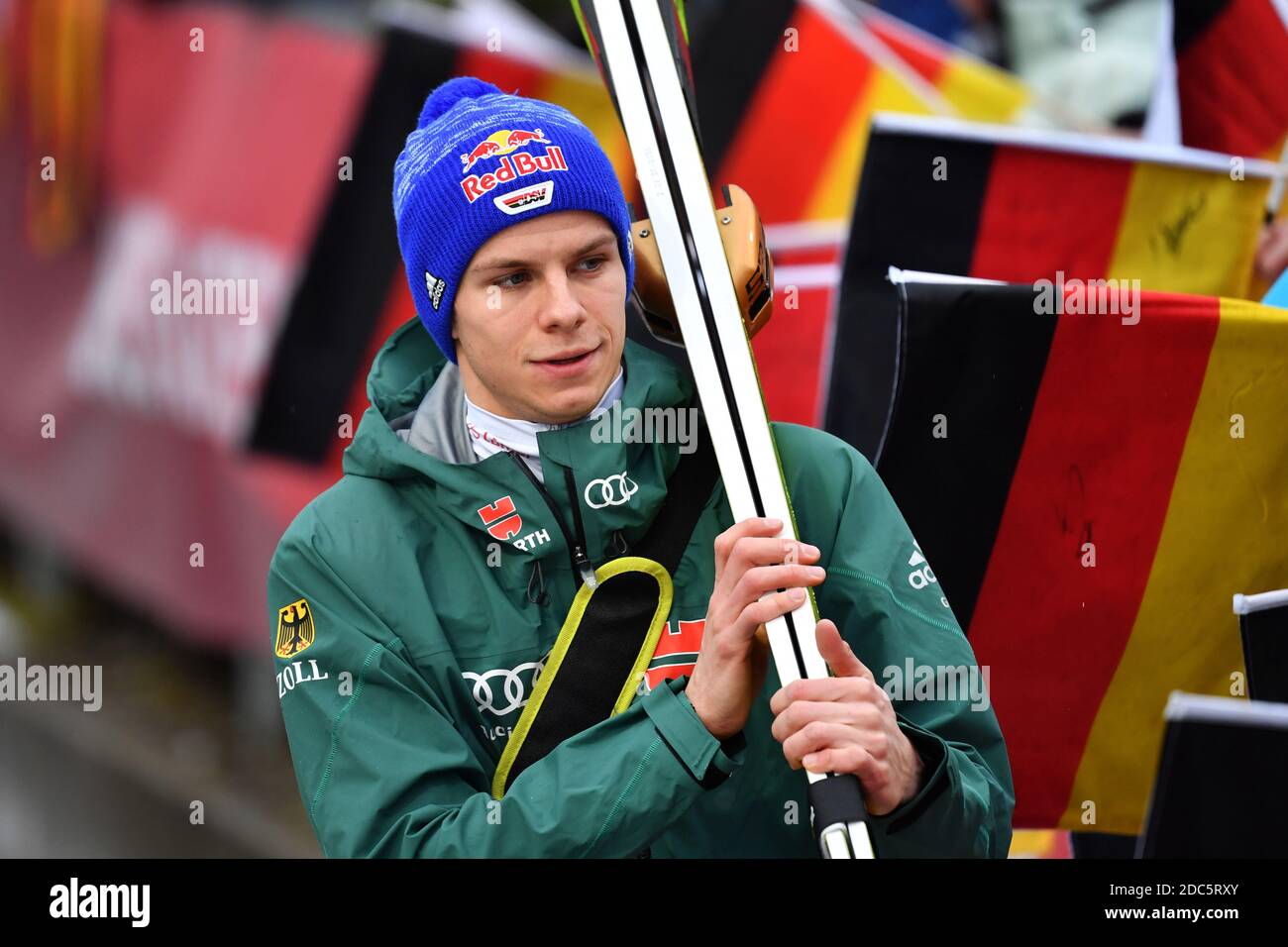 Ski jumping: World Cup prelude in Wisla (POL) from November 20-22, 2020. Archive photo: Andreas WELLINGER (GER) walks along black, red and gold flags, flags, action, single image, cropped single motif, half figure, half figure. Ski jumping, 67th International Four Hills Tournament 2018/19. Opening competition in Oberstdorf, Erdinger Arena, on December 30th, 2018. Â | usage worldwide Stock Photo