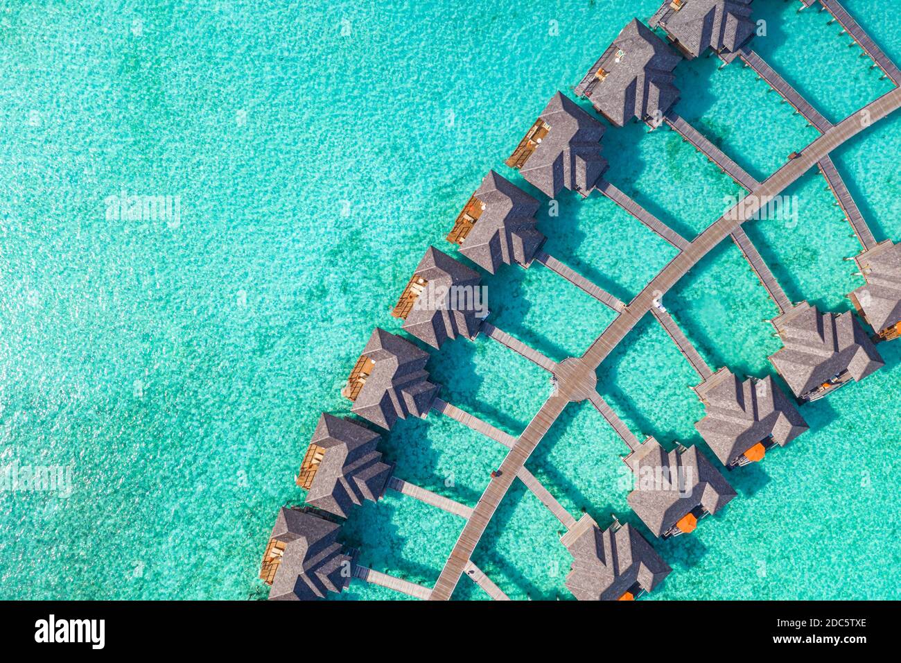 Aerial landscape with tropical resort villas, bungalow, palm trees and amazing sea shore. Travel destination, luxury vacation, summer nature scene Stock Photo