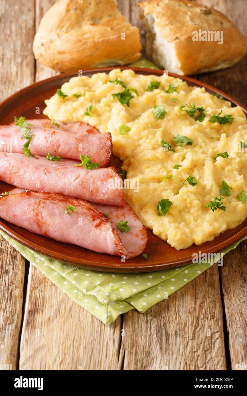 Pease Pudding is an easy, British side dish traditionally serve with ham closeup in the plate on the table. Vertical Stock Photo