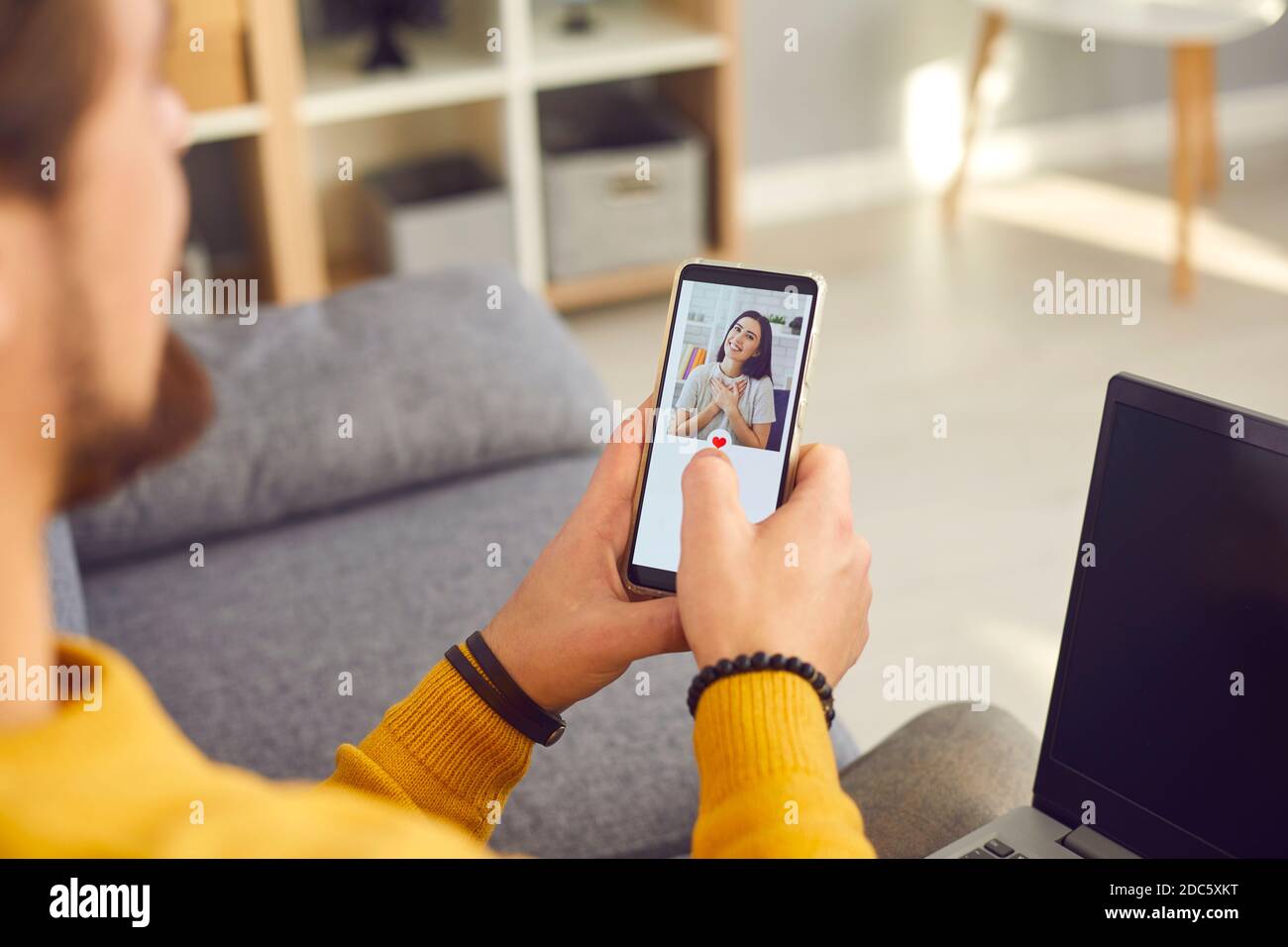 Single young man using a modern mobile dating application to look for a girlfriend Stock Photo