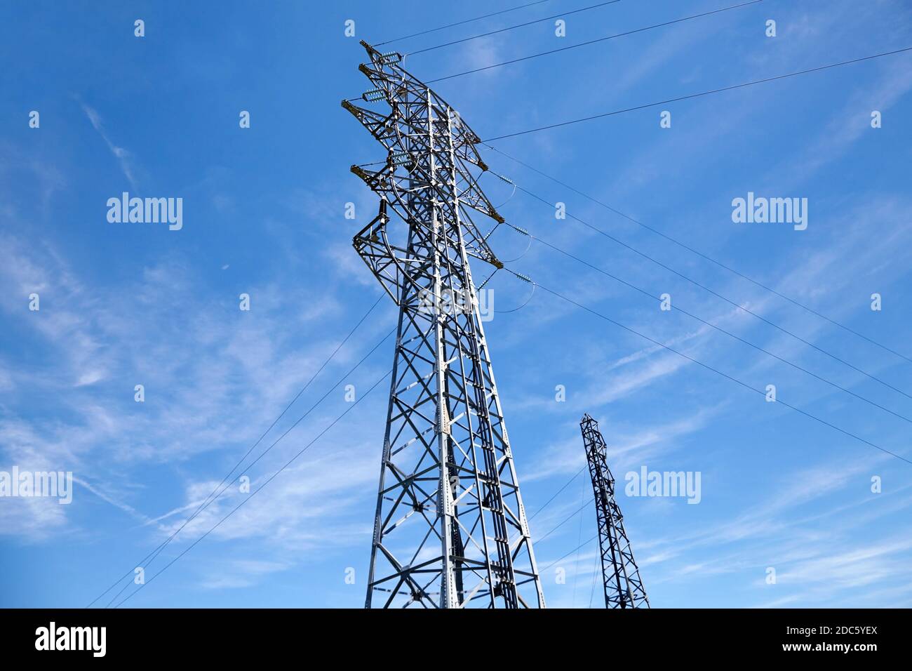 High voltage power line. Poles and wires against the blue sky ...